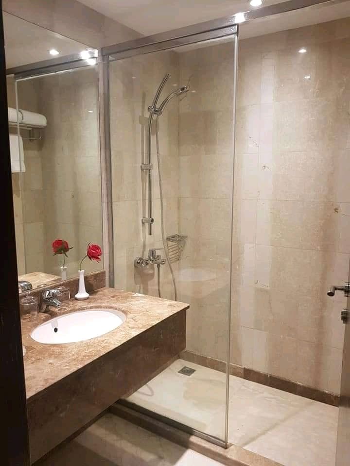 Hotel bathroom detail with fresh roses