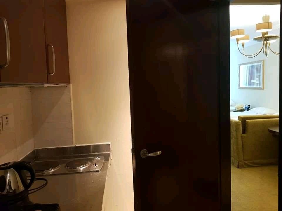 Hotel kitchenette opening into the bedroom
