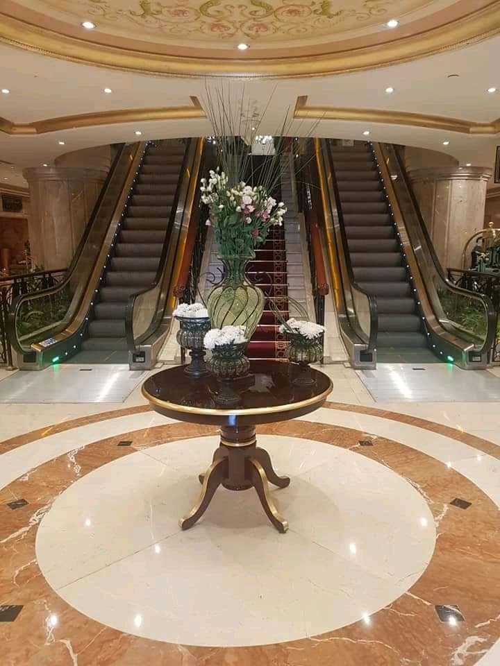 Hotel lobby escalators with a floral centerpiece