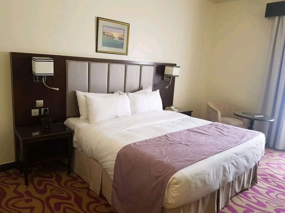Elegant hotel bedroom with lavender bedding