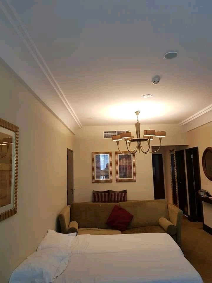 Hotel suite with chandelier and lounge seating