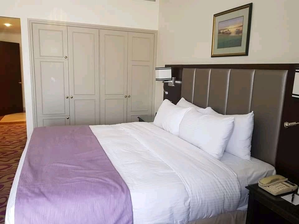 Hotel bedroom with wardrobe and city view