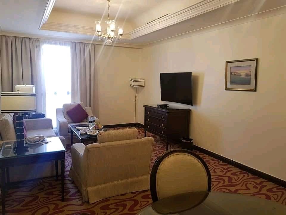 Spacious hotel suite lounge with plush seating